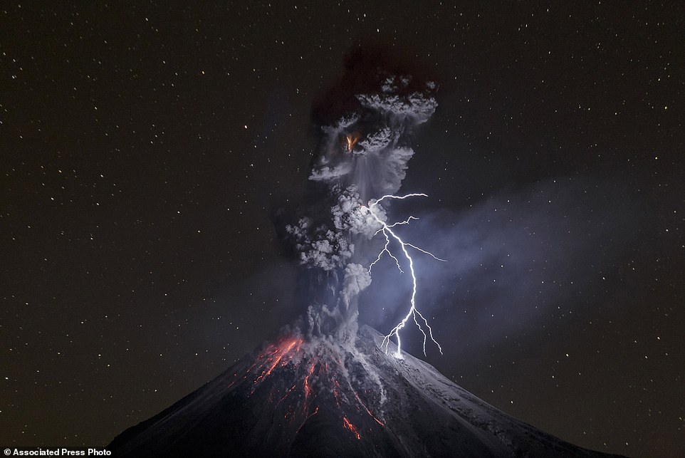 In this image released by World Press Photo titled "The Power of Nature" by photographer Sergio Tapiro which won the third prize in the Nature Singles category shows a powerful night explosion of the Colima Volcano with lightning, ballistic projectiles and incandescent rockfalls, Comala municipality in Colima, Mexico, 13 December 2015. (Sergio Tapiro, World Press Photo via AP)