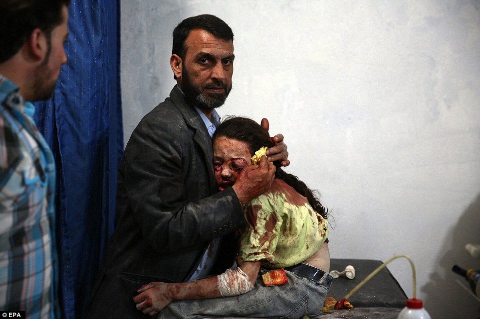 31571ECE00000578-3452659-The_picture_shows_a_wounded_Syrian_girl_holding_on_to_a_relative-a-31_1455810915466