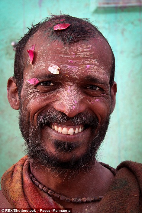 3171276A00000578-3458257-A_man_covered_in_colour_and_petals_during_Holi-a-94_1456147900694