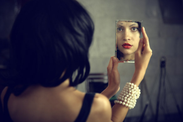 woman-looking-herself-in-mirror