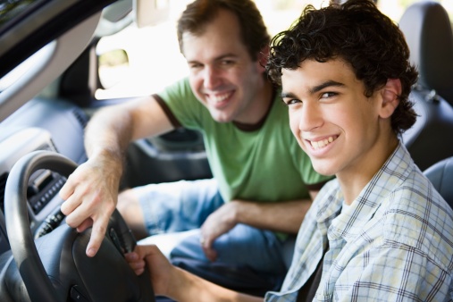 Father teaching son how to drive