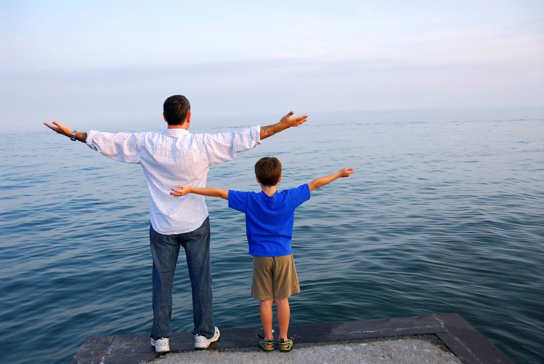 Father and son on a pier relaxing together