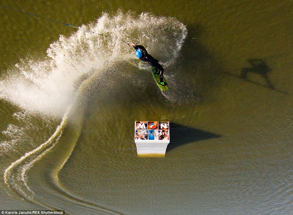 2ACC5ADB00000578-3173355-Thrillseeking_adventures_A_wakeboarder_doing_some_tricks_in_a_wi-a-46_1437748383342