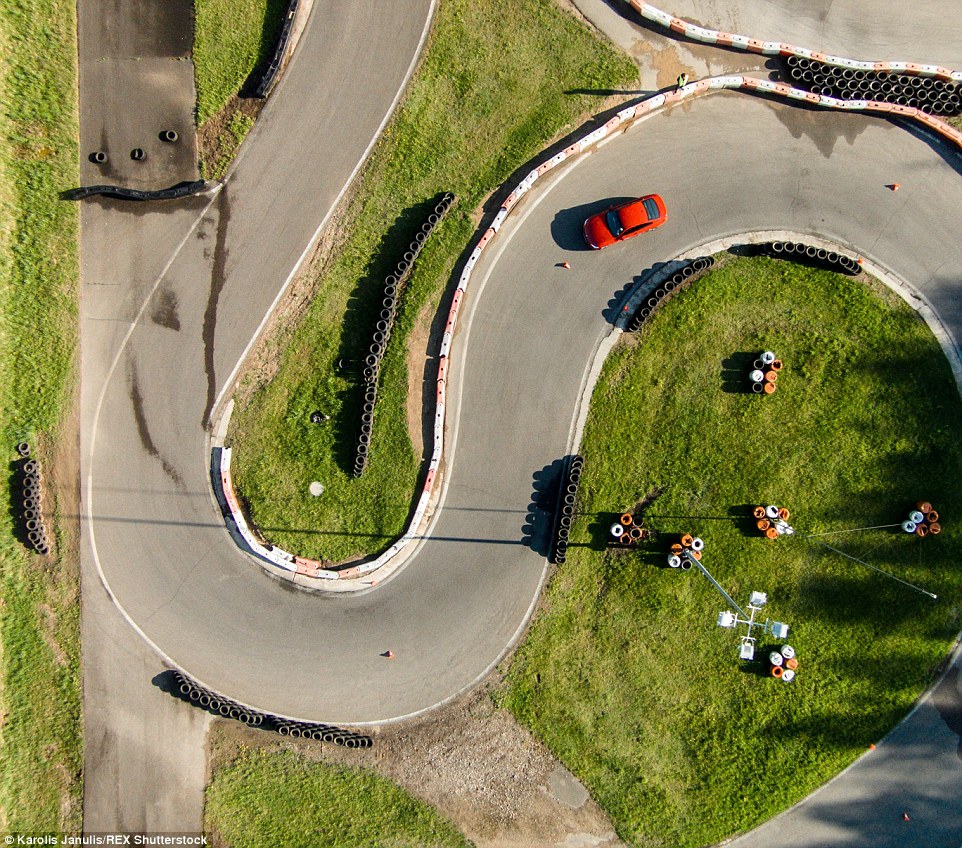 2ACC5B5A00000578-3173355-Race_day_A_red_car_driving_through_the_winding_lanes_lined_with_-a-34_1437748383329