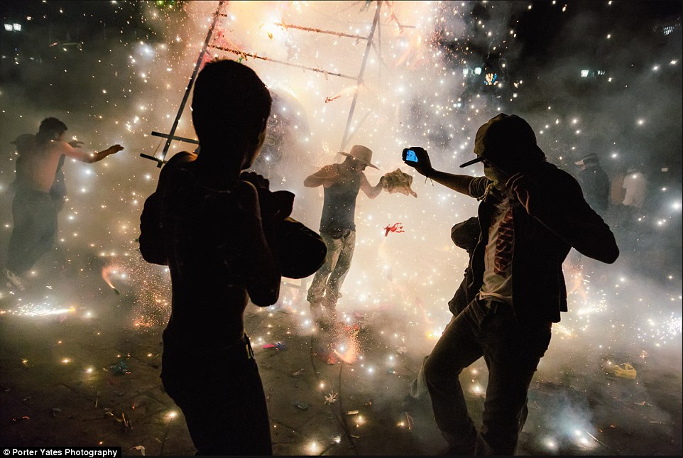 2D04A5B400000578-3257757-Men_amid_a_shower_of_sparks_from_fireworks_at_the_National_Pyrot-a-98_1443800119421