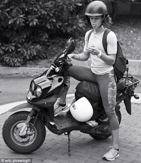 2D5E732E00000578-3270660-Just_checking_A_moped_rider_stops_to_look_at_her_phone-a-68_1444741347187