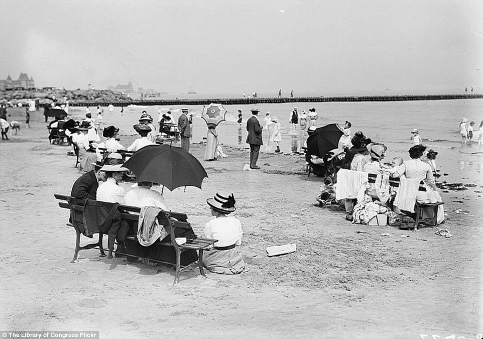 2DA0E14700000578-3282754-Scenes_on_Coney_Island_show_women_relaxing_with_parasols_and_lon-a-39_1445587040683