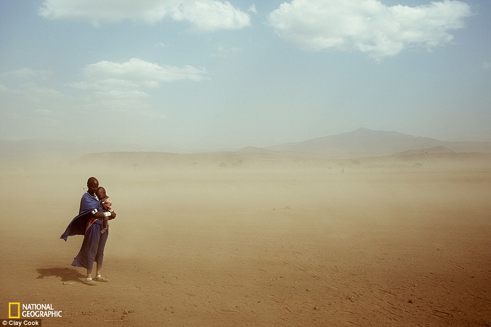 2DD7511500000578-3291921-Hold_Tight_A_woman_holds_her_child_close_during_a_sandstorm_in_a-a-71_1445962726558
