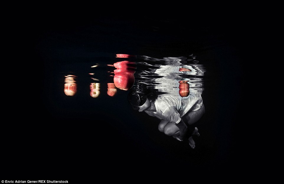 2E2BA2C400000578-0-Unusual_creations_This_unusual_image_shows_a_masked_swimmer_surr-a-68_1446818559667