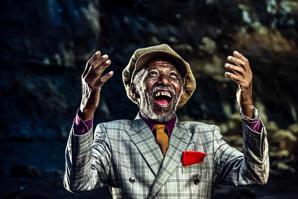 Old smartly dressed man laughing towards the heavens after some good fortune.