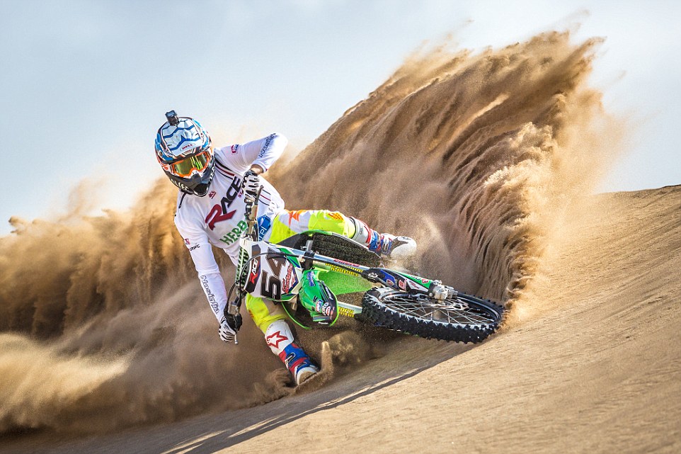 Motocross rider surfing dunes in Villa Gesell, Argentina.