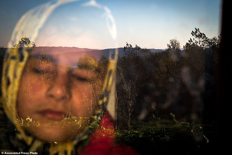 In this image released by World Press Photo titled "Into the Light" by photographer Zohreh Saberi which won the third prize in the Daily Life Singles category shows Raheleh, who was born blind, standing behind the window in the morning. She likes the warmness of the sunlight on her face. Babol, Mazandaran, Iran, Nov. 12, 2015. (Zohren Saberi/Mehrnews Agency, World Press Photo via AP)