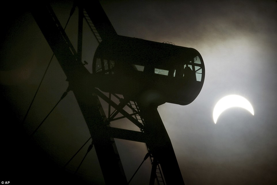 320351FC00000578-3482995-A_partial_solar_eclipse_is_seen_behind_a_passenger_capsule_of_th-a-2_1457509410389